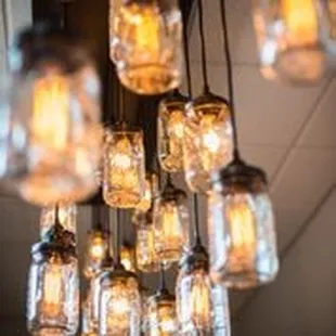 a cluster of mason jars hanging from the ceiling