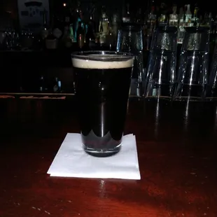 a pint of beer on a napkin