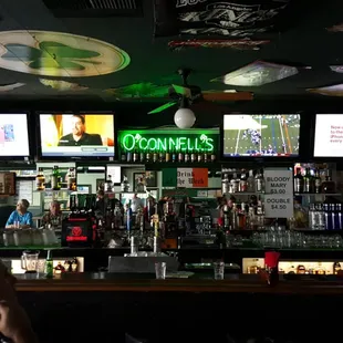 a bar with people sitting at the bar