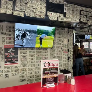 a bar with a red counter and a tv