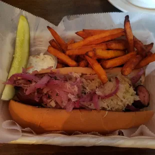 Polish sausage with saurkraut and grilled onions/ sweet potato fries