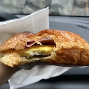 Breakfast croissant with eggs/ham/bacon/cheese. It was freshly toasted, delicious, and flaky!