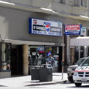 a police car parked in front of a liquor store