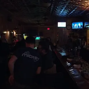 a bar with people sitting at the bar
