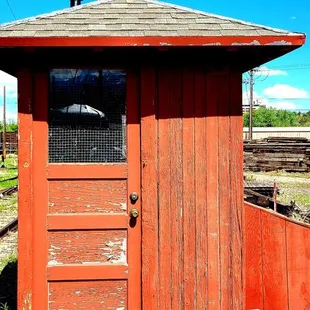 an old outhouse in a field
