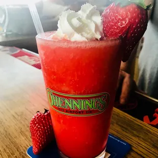 a drink with strawberries and whipped cream