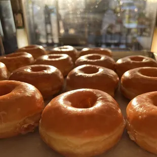 a tray of glazed donuts