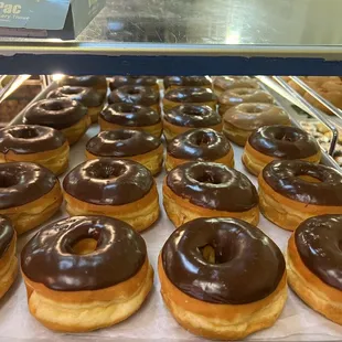 a display of chocolate frosted donuts