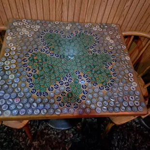 a table made out of beer bottle caps