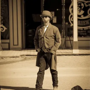 People in western garb around town
