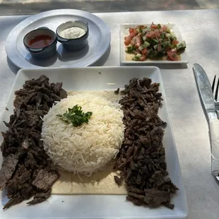 Beef Doner Kebab over rice with salad and sauces