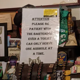a sign that reads attention please be patient with the bartender even a toilet can only serve one