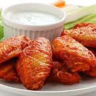 a plate of buffalo wings with ranch dip