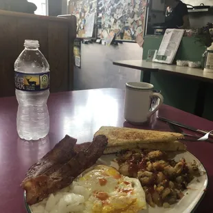 Eggs fried, onions, home fries, and onions with coffee , of course