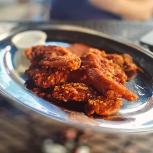 Chicken fingers tossed in wing sauce