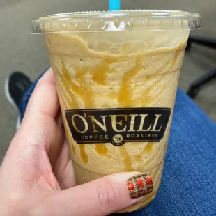 a hand holding a cup of coffee