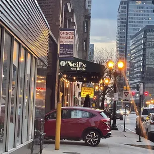 a red car parked on the sidewalk