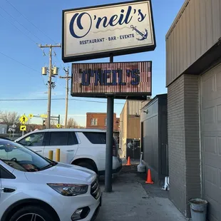 cars parked in front of a restaurant