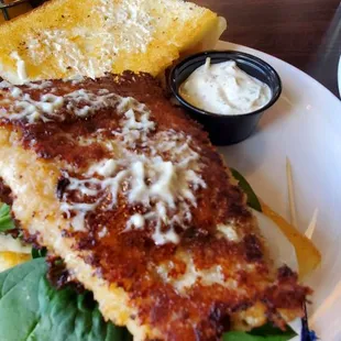 Parmesan crusted walleye sandwich, with the top of the bun off to the side.