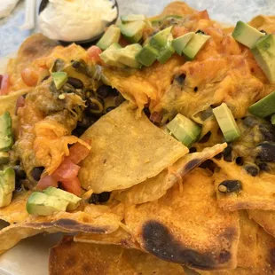 Burned nachos with crusty, out of date beans.