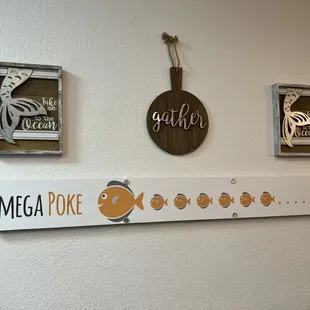 a wall with a sign and a clock