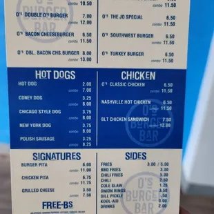 a hand holding a menu