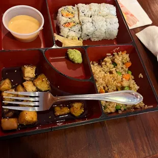 a plate of food with rice, tofu, and vegetables