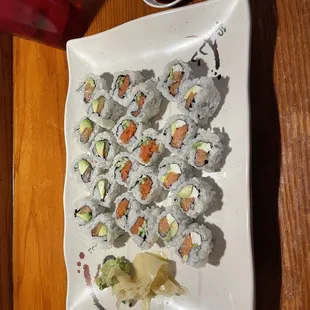 a plate of sushi and chopsticks