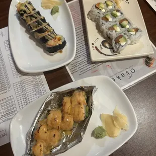 Baked Salmon Roll (bottom of photo), Lobster Roll (top left), and Philadelphia Roll (top right)