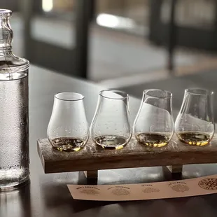 four glasses and a bottle