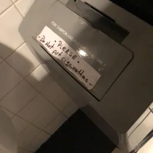 Ladies, don't risk igniting used tampons...  someone actually did this for there to be a signage need.