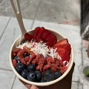 Acai bowl with my 6 toppings: strawberries, blueberries, goji berries, coconut flakes, granola, and honey.