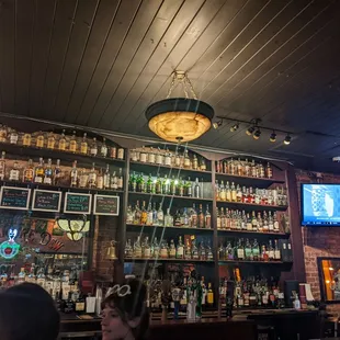 a bar with many bottles of alcohol