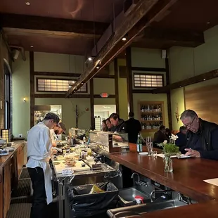 a group of people in a restaurant preparing food