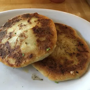 Carnita pupusa with the slaw on the side that is normally on top