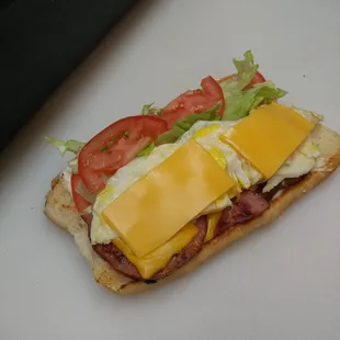 Ham egg and cheese poboy on toasted bread