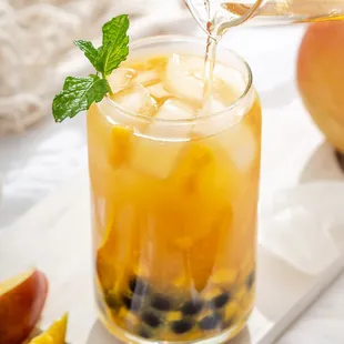 a pitcher pouring a drink into a glass