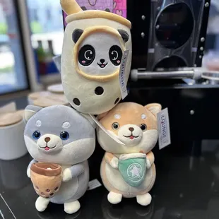 three stuffed animals on a counter