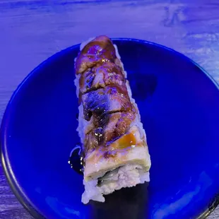 a piece of sushi on a blue plate