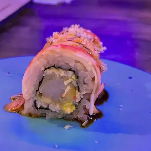 a sushi roll on a blue plate