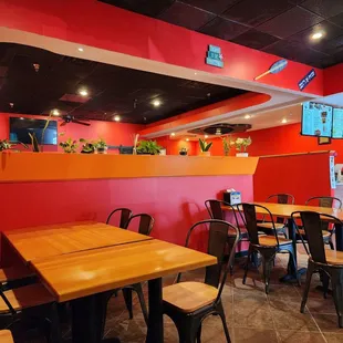 a dining area with tables and chairs