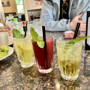 three cocktails on a table