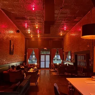 a dimly lit restaurant with red lights