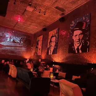 people sitting at tables in a dimly lit restaurant