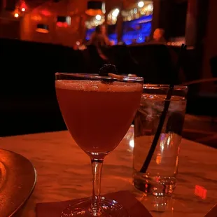 a cocktail in a coupe glass on a table
