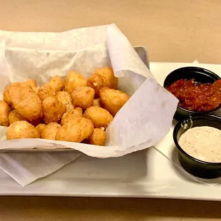 a basket of tater tots and dipping sauce