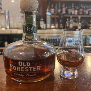 a bottle of old forester and a glass of brandy