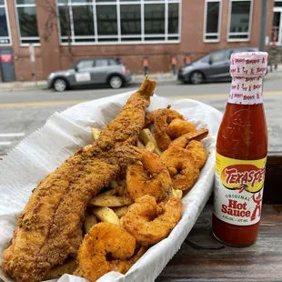 a basket of fried fish and fries