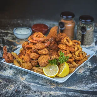 a plate of fried shrimp and fries