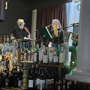 a man playing an accordion behind the bar